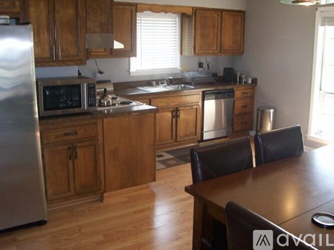 A kitchen with wooden cabinets and stainless steel appliances.