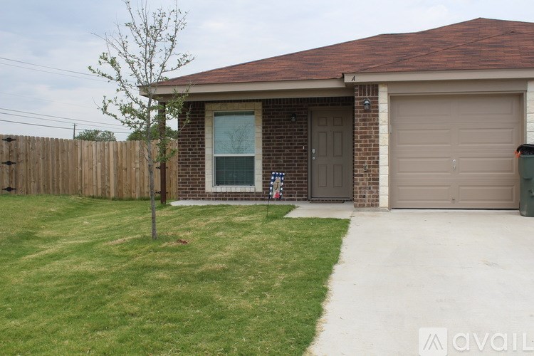 A house with a brown roof and a grey garage door.