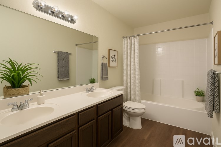 A bathroom with a white sink and a white toilet.
