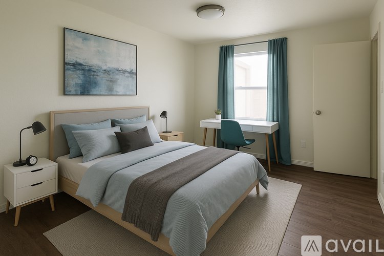 A bedroom with a large bed and a painting on the wall.