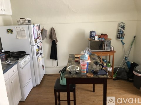 A kitchen with a table and chairs in the middle of it.