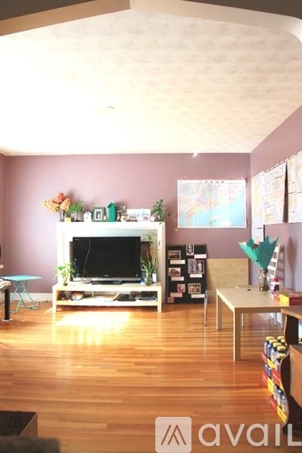 A living room with a television and a table.