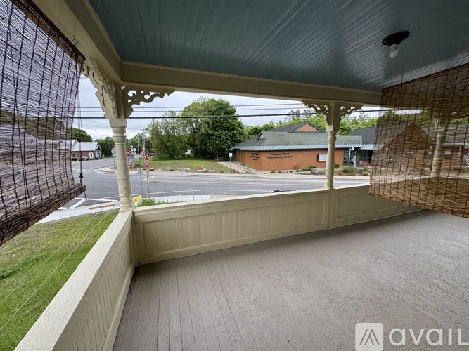 A balcony with a view of a street and buildings.