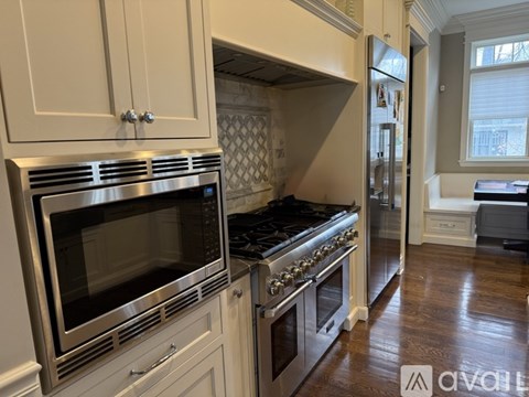 A kitchen with a stainless steel oven and microwave.