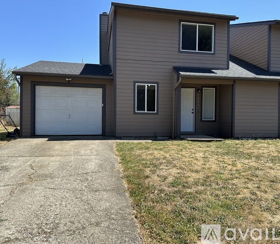 A house with a garage and a door is available for rent.