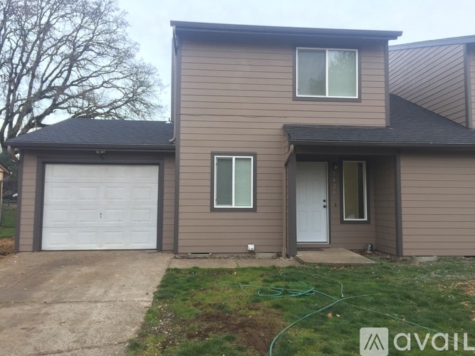 A house with a garage and a door is available for rent.