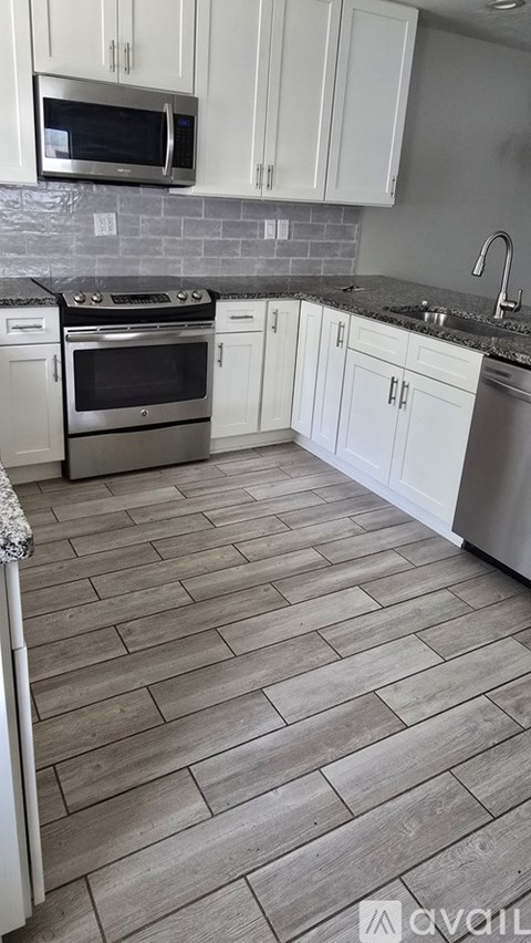 A kitchen with a stove top oven and a microwave above it.