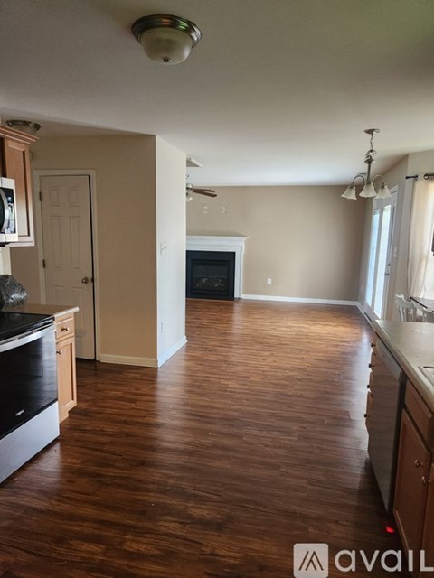 A kitchen with wood floors and a black oven.