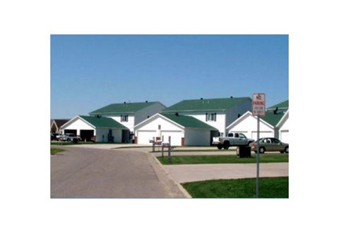a neighborhood of houses with green roofs and a no parking sign