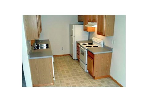 a small kitchen with a stove and a refrigerator