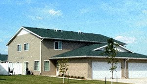 Exterior Belsly a house with a garage and a tree in front of it