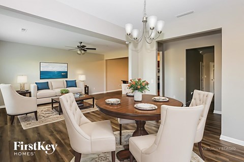 A dining room with a wooden table set for four.