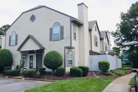 A house with a grey facade and a black door.