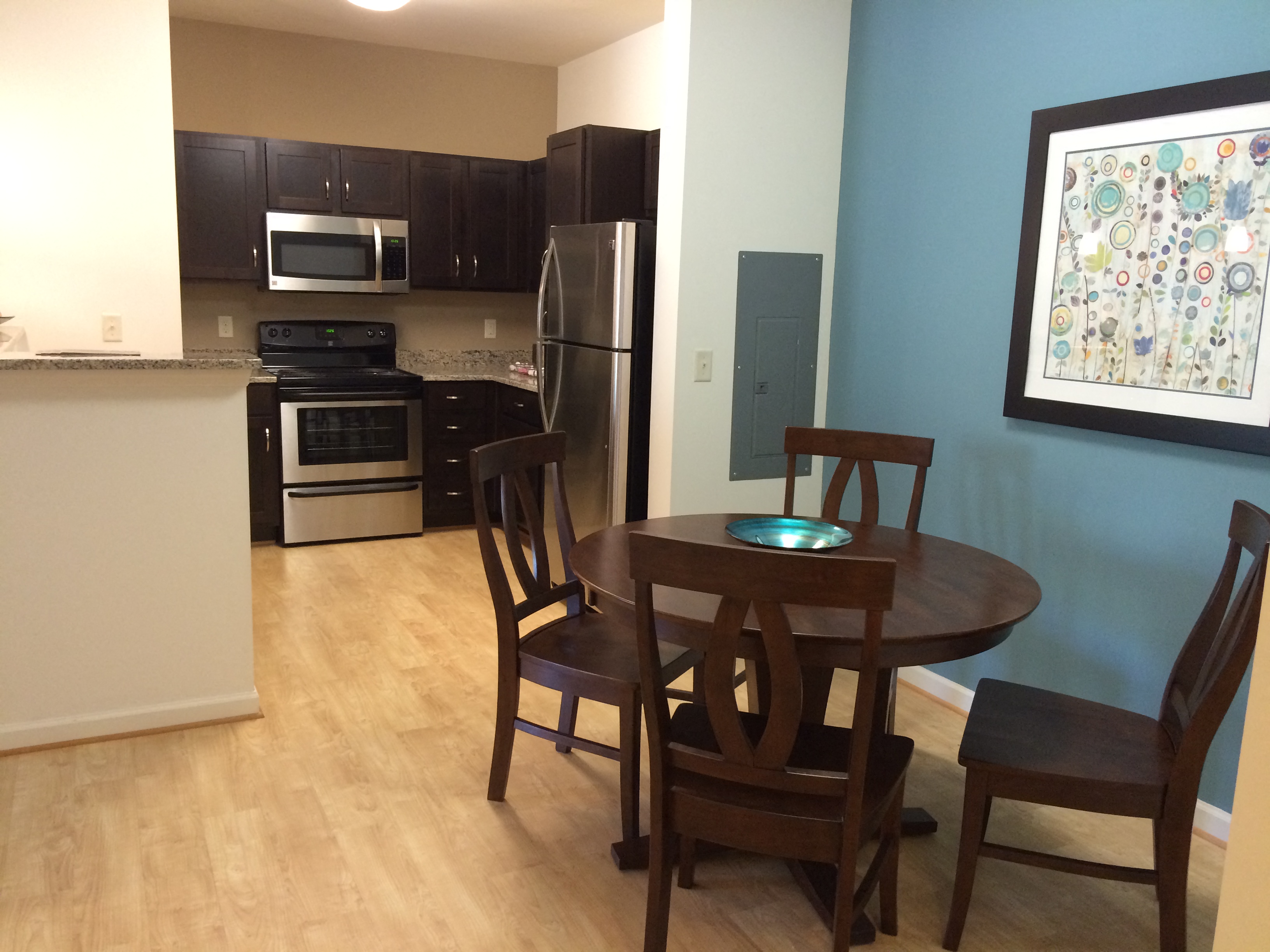 a kitchen and dining room with a table and chairs
