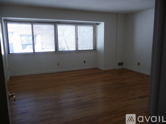 A room with wooden floors and a large window.