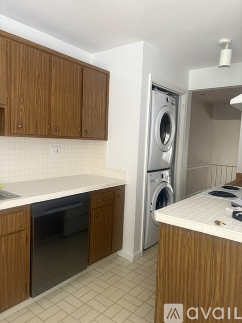 A modern kitchen with a washing machine built into the cabinetry.