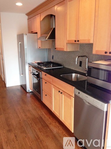 A kitchen with wooden cabinets and stainless steel appliances.