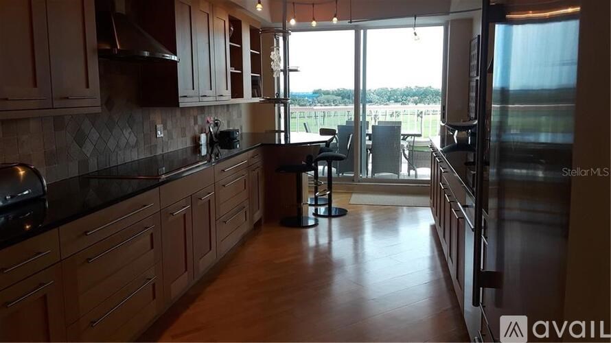 A kitchen with wooden cabinets and a black countertop.