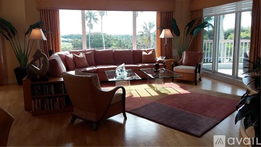 A living room with a sofa, armchairs, and a coffee table.