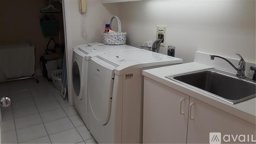 A small laundry room with a washer and dryer.