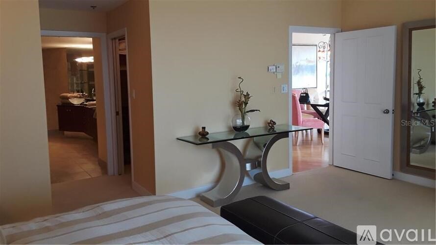 A living room with a glass table and a sofa.