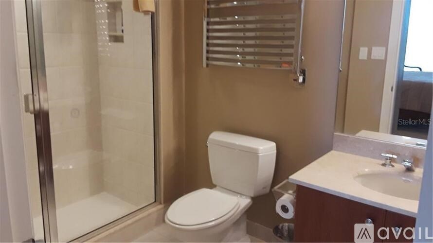 A bathroom with a toilet, sink, and shower.