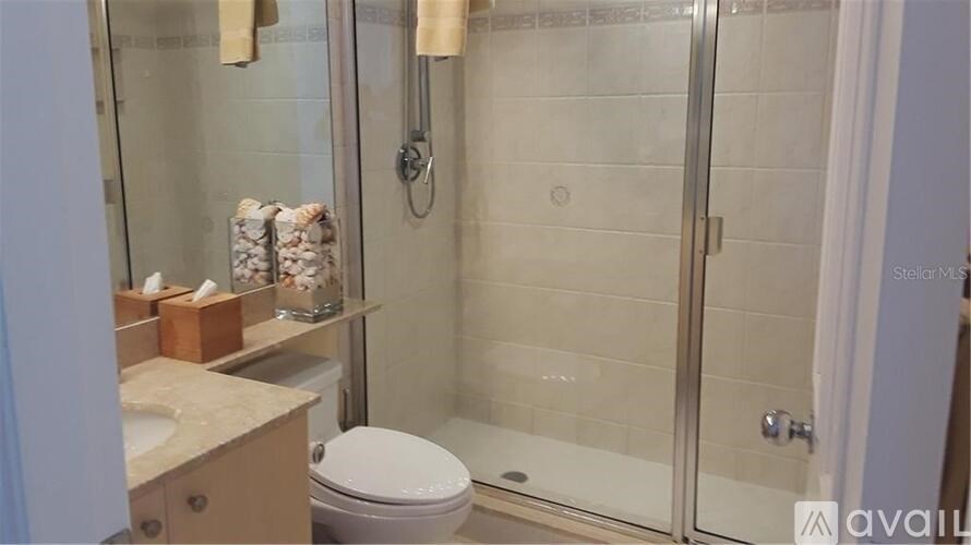 A bathroom with a toilet, sink, and shower.