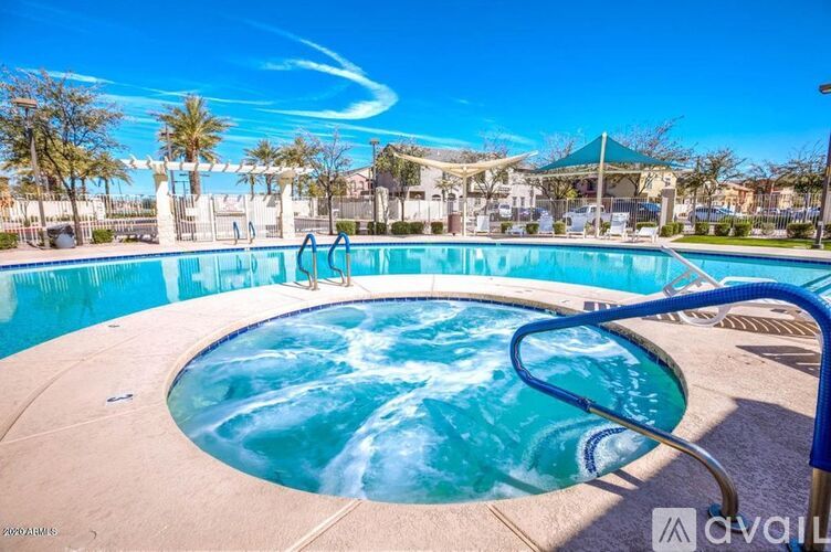 A round swimming pool with a blue tiled edge and a metal ladder on the side.