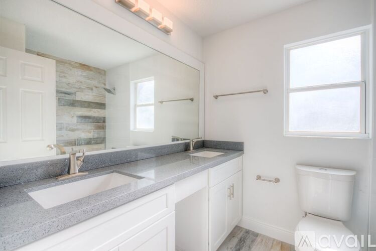 A bathroom with a stone wall and a window.