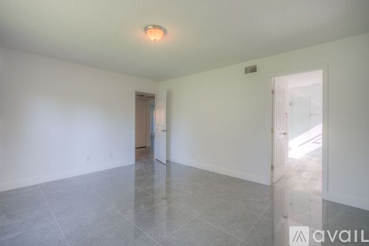 A spacious room with a tiled floor and a ceiling light.