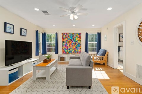A living room with a grey couch and a television.