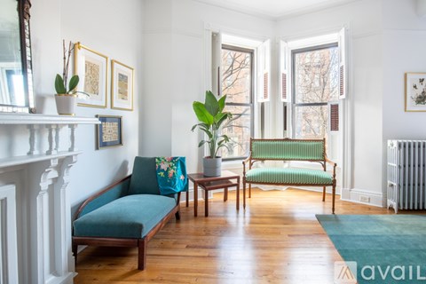 A living room with a blue couch and a green chair.