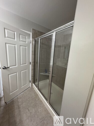 A white door with a glass panel to the right.