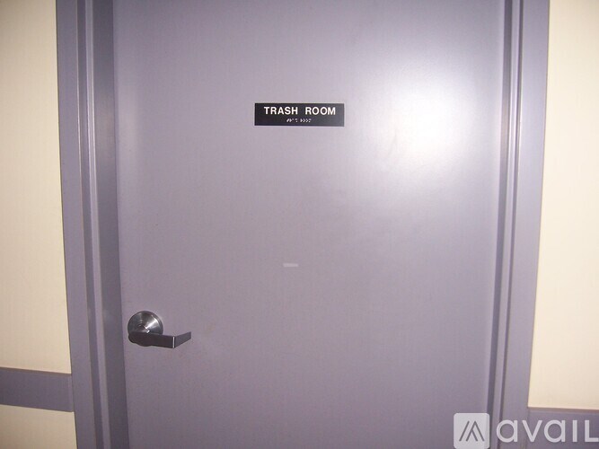 A door with a sign that says "TRASH ROOM".