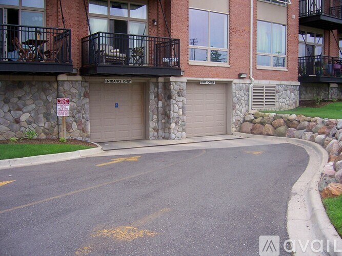 A building with a stone wall and a garage door.