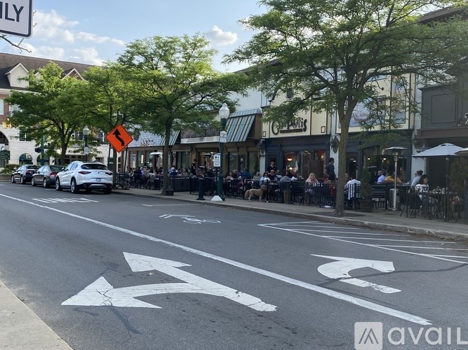 A street with a white arrow on the road indicating a turn.