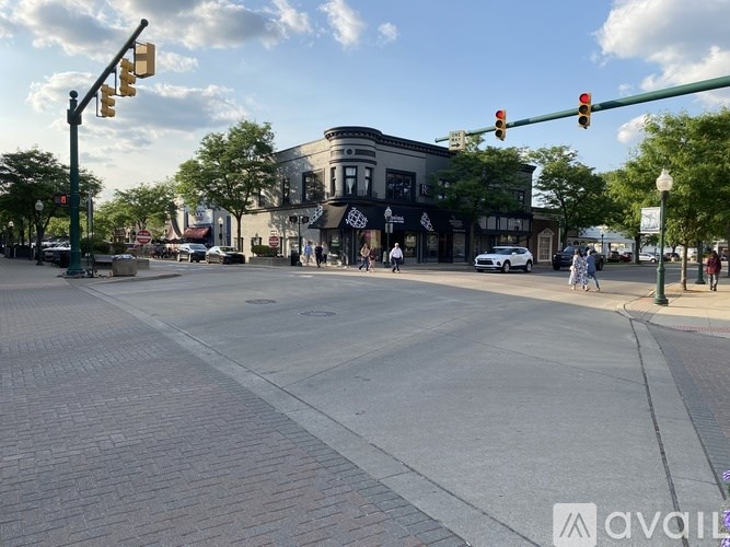 A street view with traffic lights and pedestrians.