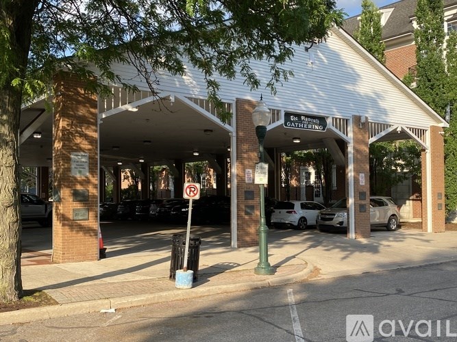 A parking garage entrance with a no parking sign in front.