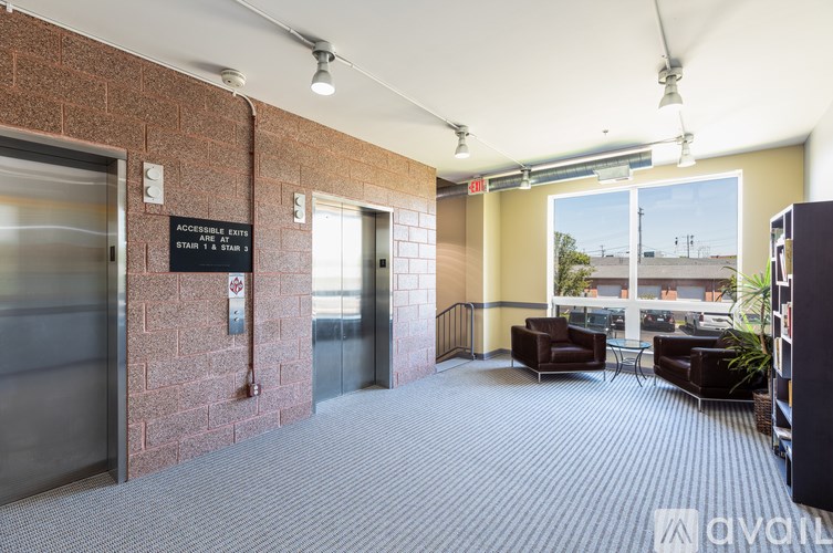 A sign in a hallway indicates the location of the accessible entrance and the first four floors.