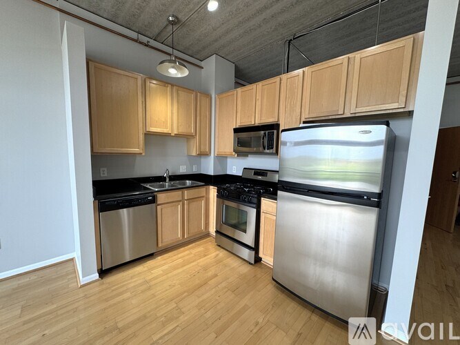 A kitchen with wooden cabinets and stainless steel appliances.