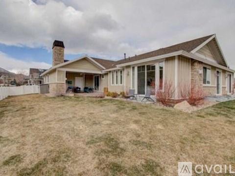 A house with a brown roof and a beige exterior is available for sale.