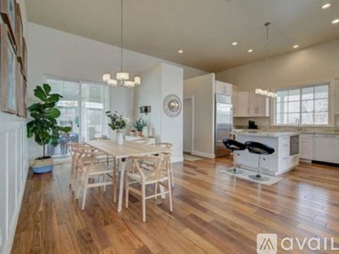 A modern kitchen with a dining table and chairs.
