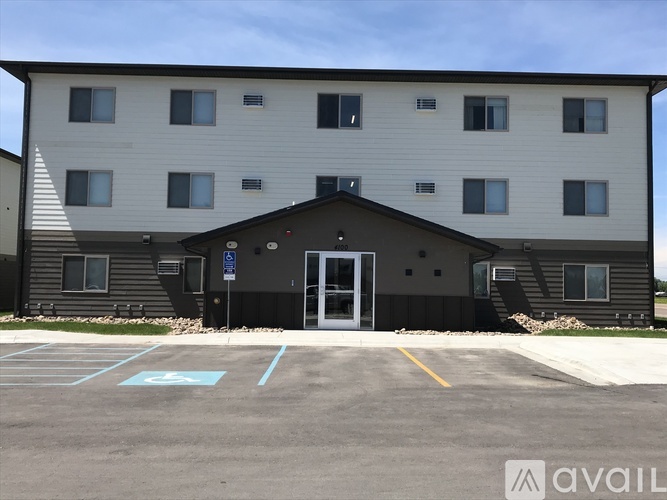 A building with a parking lot in front of it.