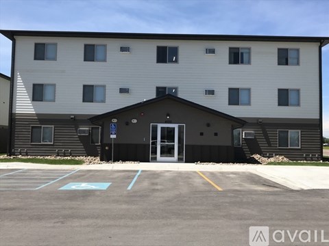 A building with a parking lot in front of it.