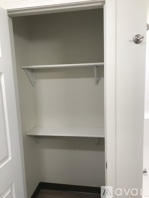 A white door with a shelf inside it.