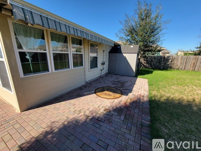 A house with a brick walkway leading to a garage.