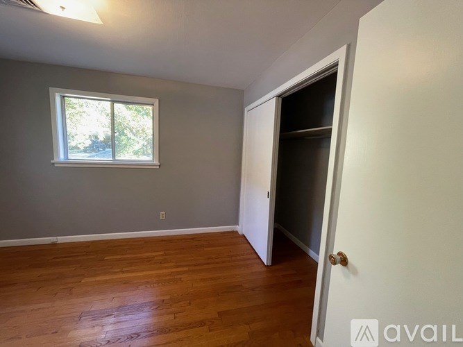 A room with a wooden floor and a window.