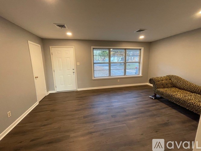A room with a couch and a window.