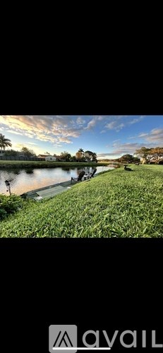 A serene landscape with a body of water and lush greenery.