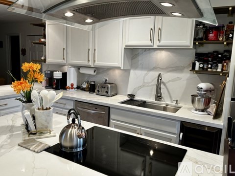 A house with a lawn and a tree in front of it.